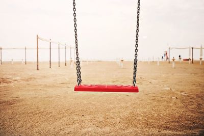 Empty swing against sky in park