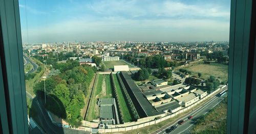 High angle view of city buildings seen through window