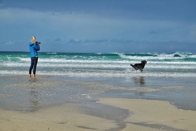 Man standing on beach against sky