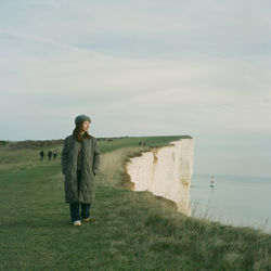 Full length of man standing on shore against sky