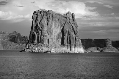 Panoramic view of rock formation in sea against sky