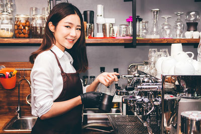 Portrait of smiling woman having food in restaurant