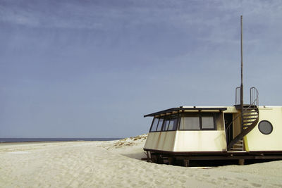 Boat on beach against sky