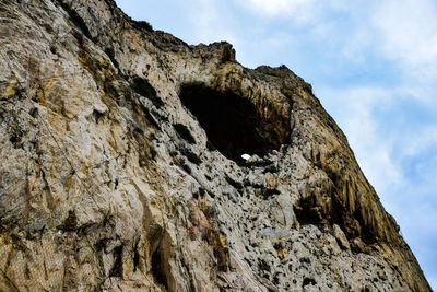 Low angle view of rock formation against sky