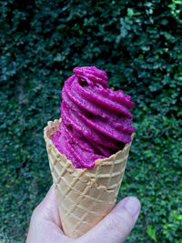 Close-up of hand holding ice cream cone