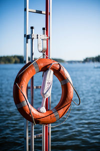 Close-up of clothes hanging on river against sky