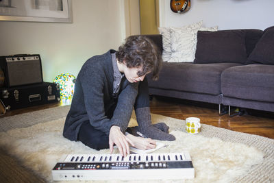 Young woman writing music