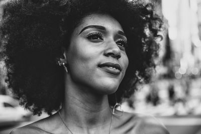 Thoughtful young woman with afro hairstyle in city