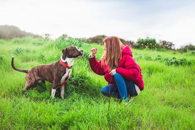 Woman with dog on field