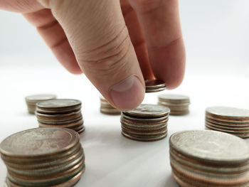 Close-up of hand holding stack of coins