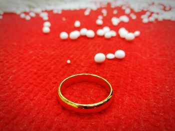 Close-up of wedding ring with decorations on table