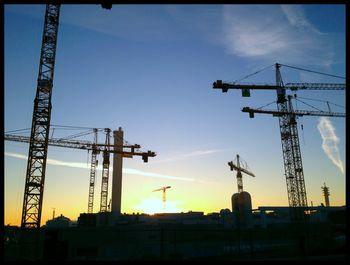 Low angle view of cranes at construction site