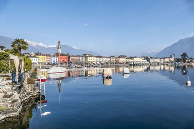 Panorama of ascona with houses with colorful facades reflecting on lake maggiore
