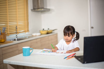 Cute girl studying at home