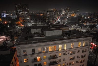 Illuminated cityscape against sky at night