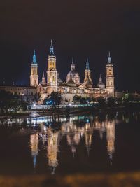 Reflection of illuminated buildings in water at night