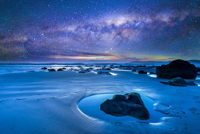 Scenic view of sea against sky at night