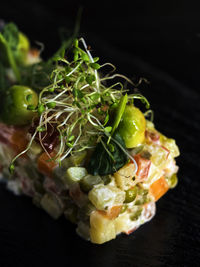 Close-up of olivier salad served on slate