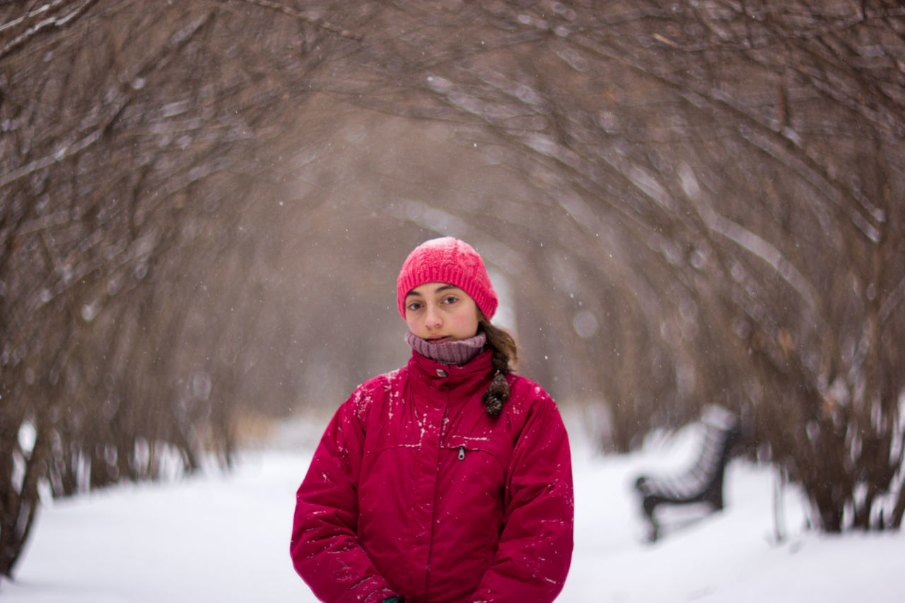 lifestyles, person, looking at camera, portrait, smiling, front view, leisure activity, casual clothing, warm clothing, winter, young adult, season, happiness, cold temperature, snow, standing, focus on foreground, red