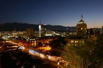 High angle view of city lit up at night