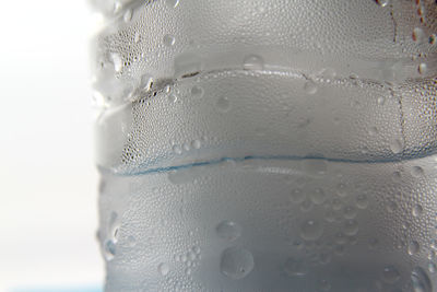 Close-up of wet glass against white background