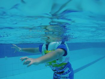 Low section of girl swimming in pool