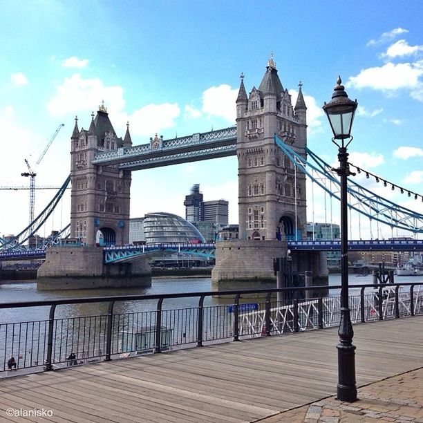 architecture, built structure, building exterior, sky, bridge - man made structure, connection, river, city, railing, water, transportation, famous place, travel destinations, travel, international landmark, capital cities, tourism, bridge, day, incidental people