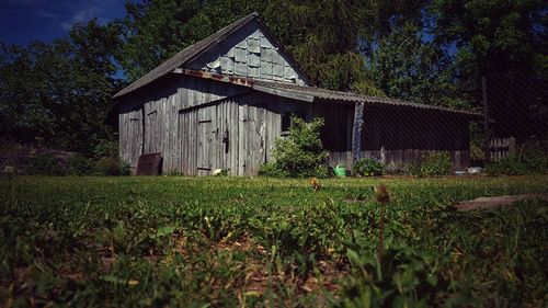 Barn on field against sky