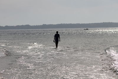 Silhouette of woman in sea