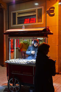 View of people sitting on wall