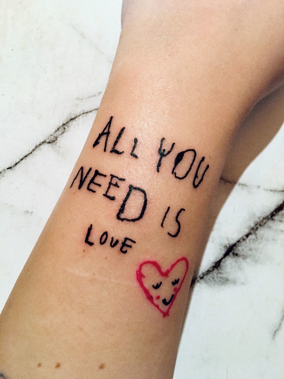 CLOSE-UP OF WOMAN HAND WITH HEART SHAPE WITH TATTOO