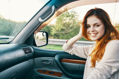 Portrait of smiling woman in car