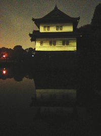 Illuminated building against sky at night