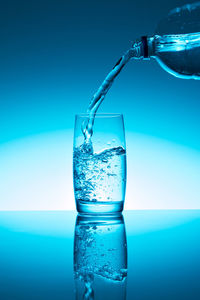 Close-up of drink in glass against blue background