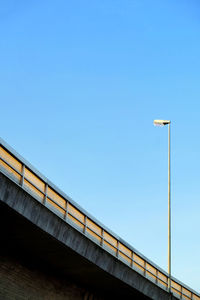 Low angle view of bridge against clear blue sky