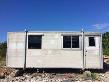 Abandoned built structure against blue sky