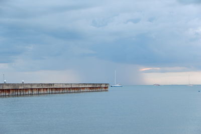 Pier over sea against sky