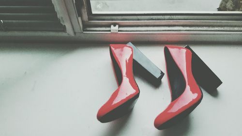 High angle view of heels on window sill