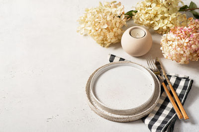 High angle view of tea cup on table against white background