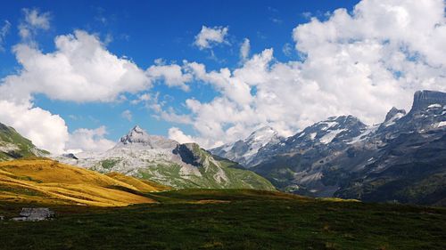 Scenic view of snow covered mountains against sky