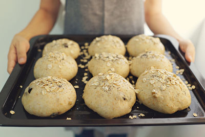 Midsection of man holding cookies in tray