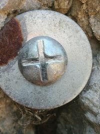 High angle view of rusty metal on rock