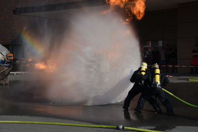 People with fire hydrant in city