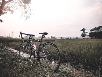 Bicycle on field against sky