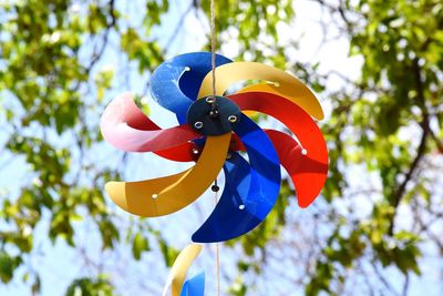 Low angle view of multi colored toy hanging on tree