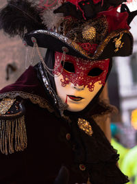 Portrait of person wearing venetian mask