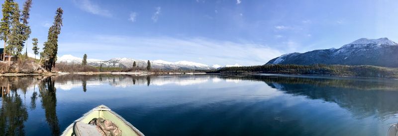 Panoramic view of lake by mountains against sky