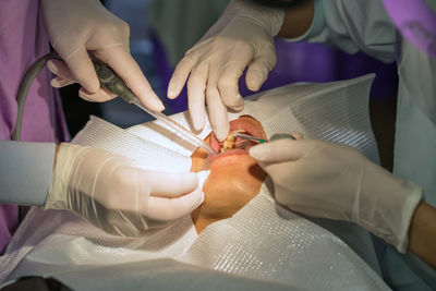 Cropped image of surgeons operating patient