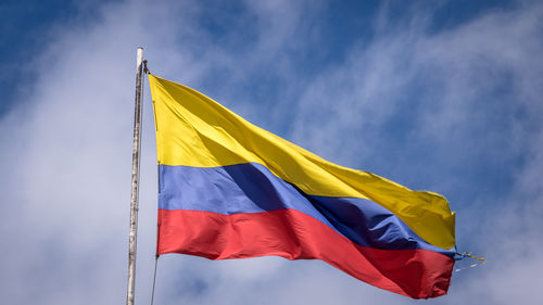 Low angle view of flag against sky