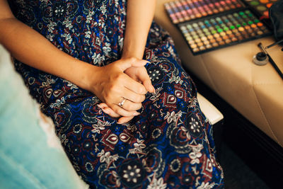 Midsection of woman sitting at home